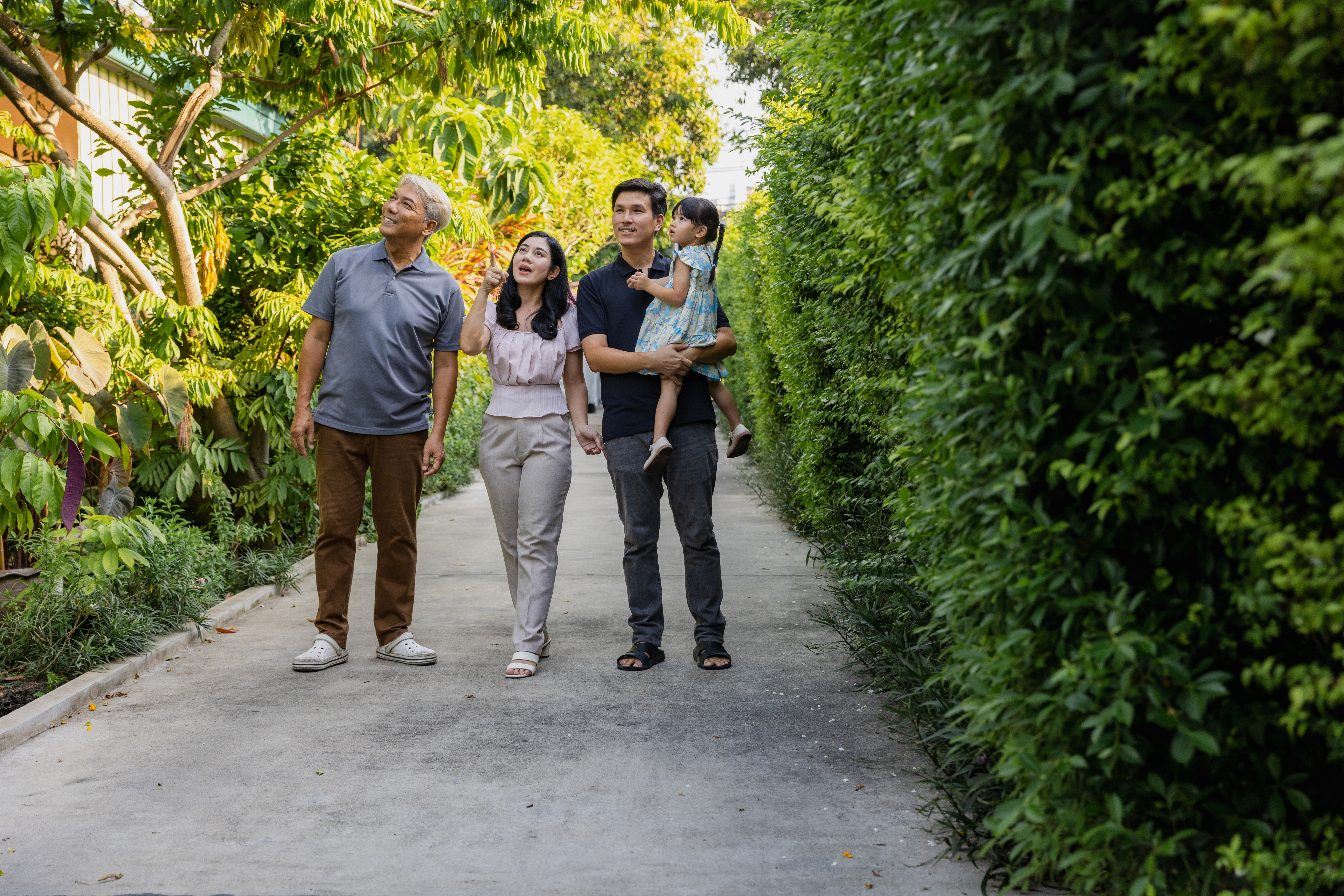 Multigenerational family with young parents walking outdoor.